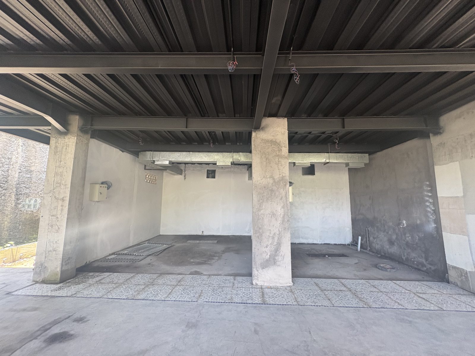 KORA unit fronts — concrete columns, steel roof, tile flooring